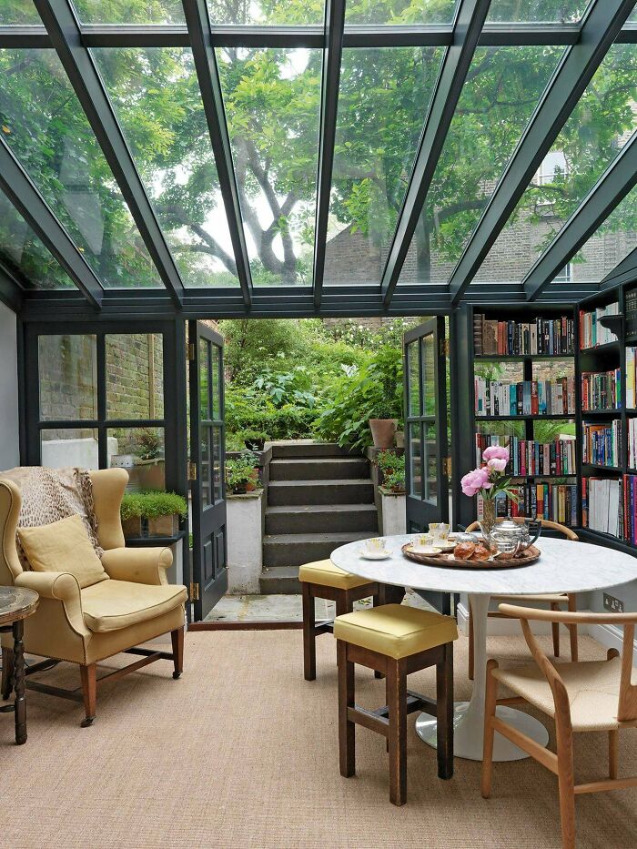 Conservatory Used As A Library Opening Up To The Garden