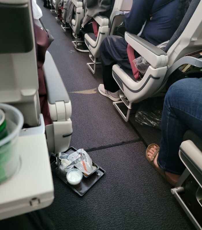 This Woman Just Dropping Her Food Tray In The Middle Of The Aisle Of The Plane