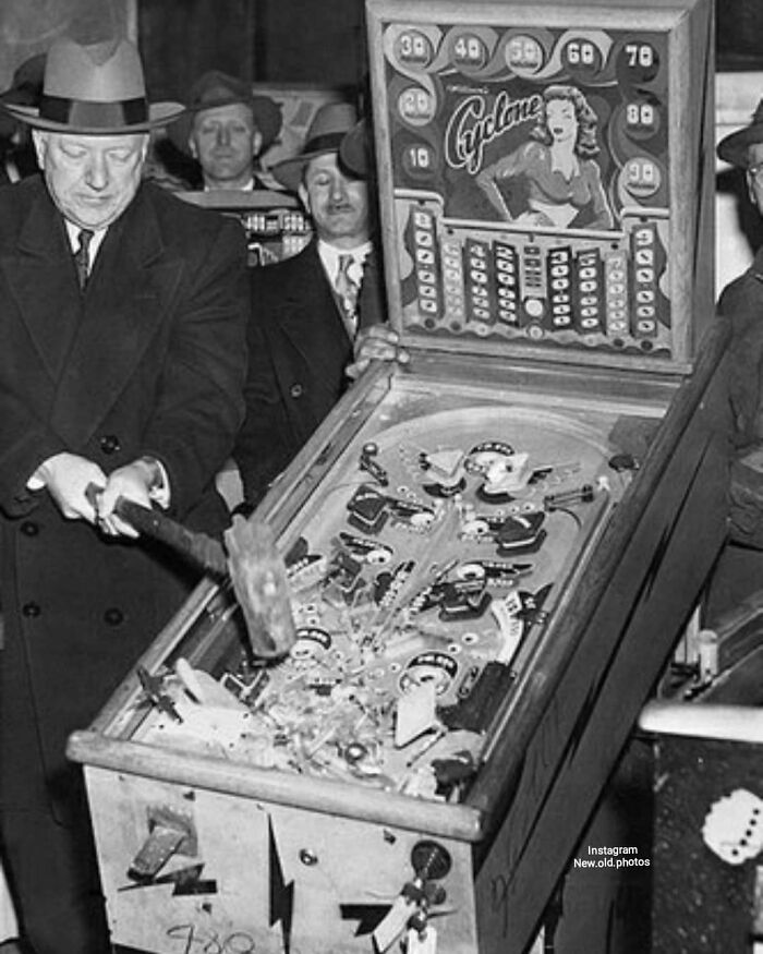 Pinball Prohibition : The Arcade Game Was Illegal In New York For Over 30 Years. Police Commissioner William O'brien Smashing A Pinball Machine In 1949
