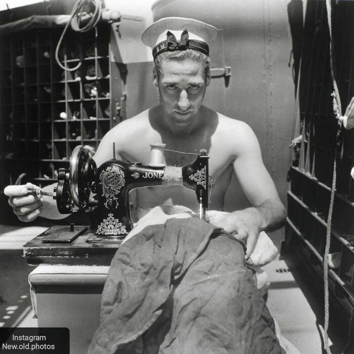 A Royal Navy Sailor On Board Hms Alcantara Uses A Portable Sewing Machine To Repair A Signal Flag During A Voyage To Sierra Leone In 1942