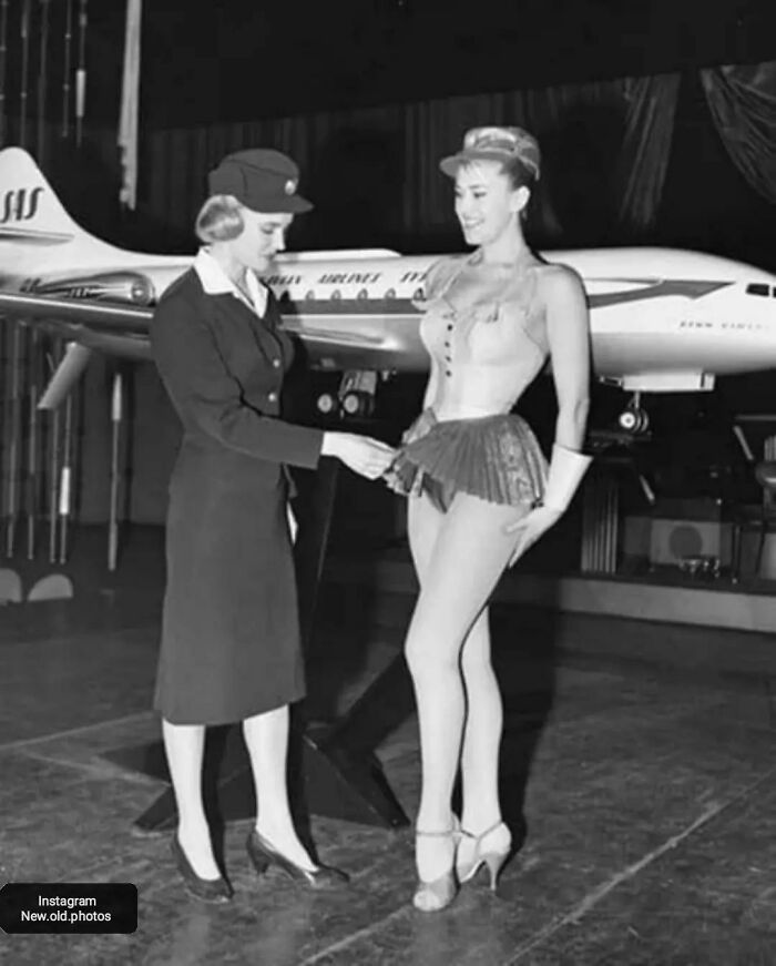 The Proposed Stewardess Uniform For Scandinavian Airlines In 1958 -1959 . The Photo Below Shows A Swedish Flight Attendant Taking A Good Look At The Clothes Of A Showgirl. According To The Grapevine In 1959, Flight Attendants Were About To Dress In A Similar Fashion!