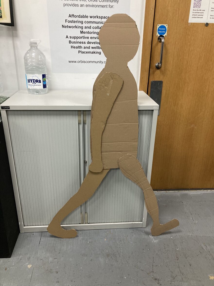 Life-Size Animated Cardboard Cut-Out Person Really Runs Round A Town. Its Head Is Changing Photos Of People Who Helped Make It Happen Who Live Here.
