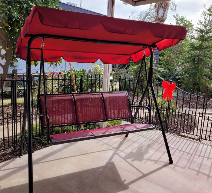  A 3-Person Patio Canopy Swing Chair That's Durable, Adjustable And Perfect For Those Chill, Swing-Back-And-Forth Kinda Days
