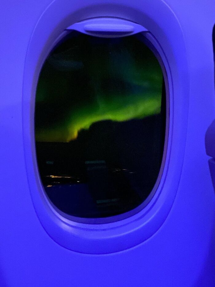 Aurora Borealis Seen Outside Of A Plane Window