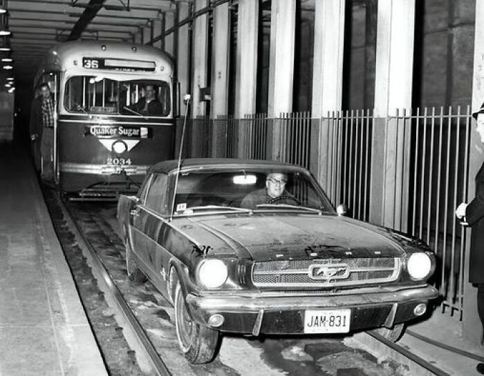 A Transit Worker Retrieves A 1965 Ford Mustang From The Subway Tracks After A Woman's Accidental Entry At 40th Street Portal, Philadelphia, 1965