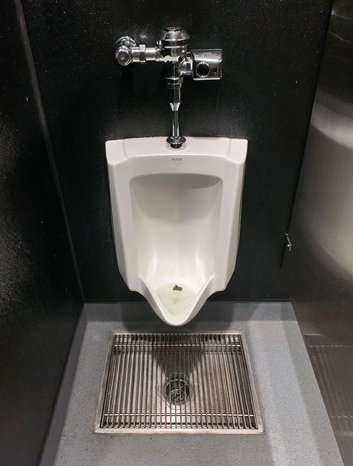 This Urinal At A Restaurant Has A Drain Below It For Catching Pee That Didn't Make It, And Also You Can Clean Bathroom With A Hose