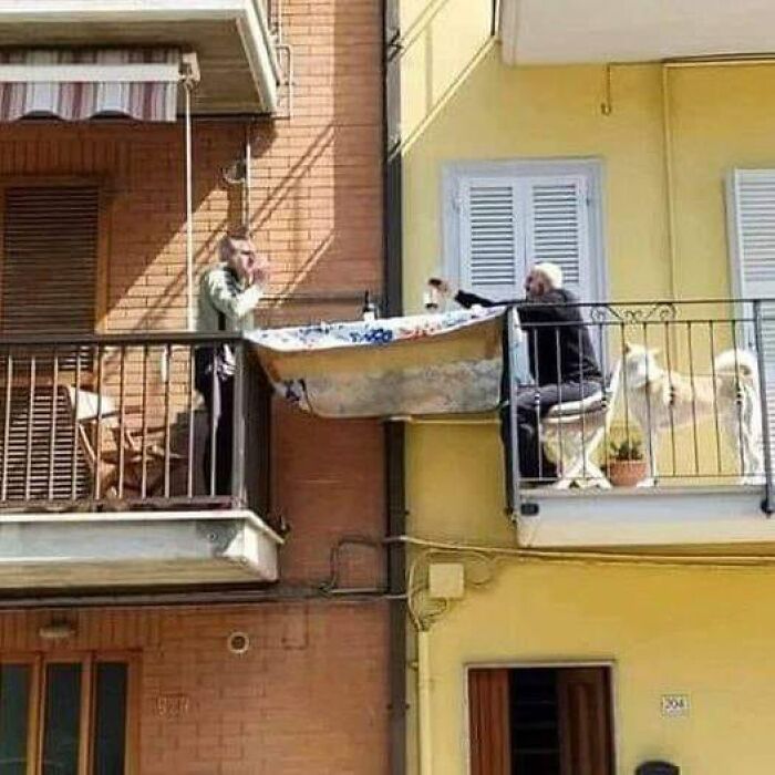 These Two Italian Men Constructed A Table In Their Balconies To Enjoy Dinner Together