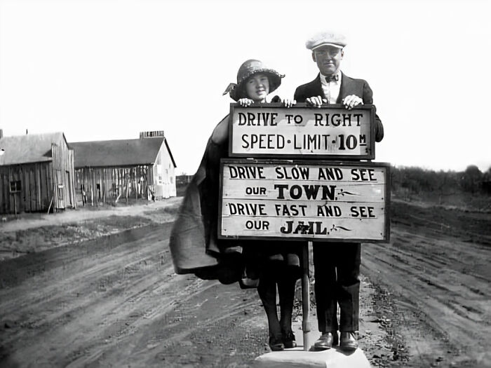 Young Couple Standing At A Speed Limit Sign. Oklahoma, 1920s