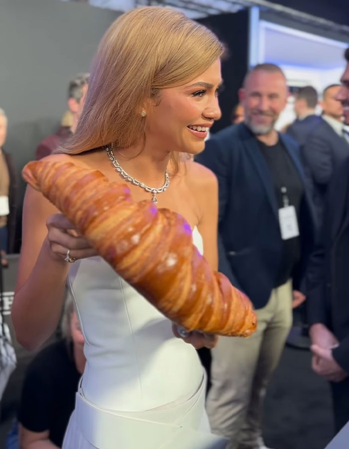 Zendaya Effortlessly Poses With The Giant Croissant She Received As A Gift At Paris Premiere