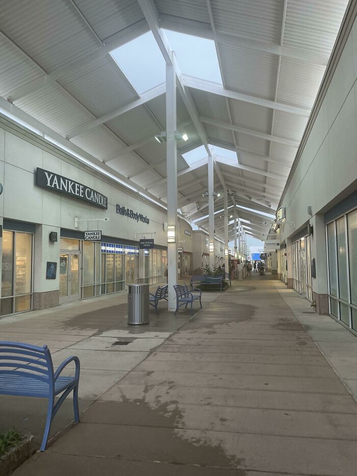 Shopping Center Has Ceilings Above Entire Walkway, Except For Where The Benches Are
