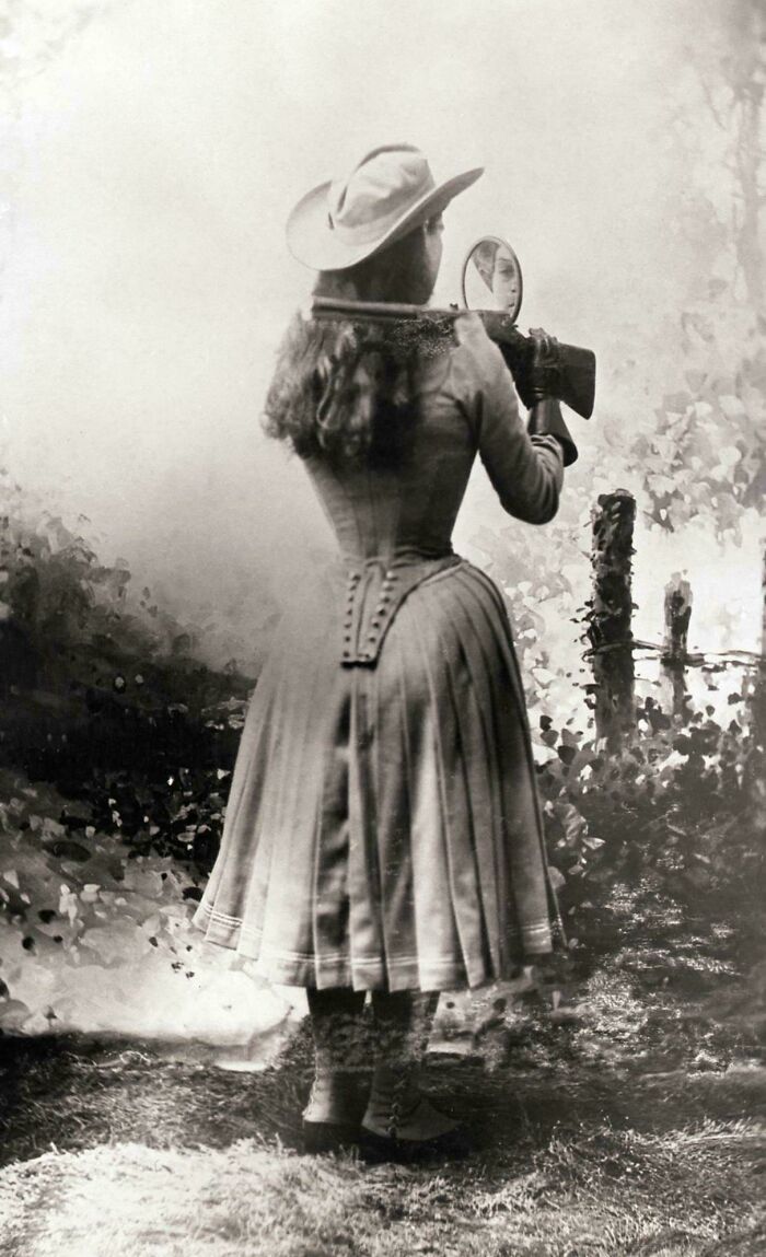 Sharpshooter Annie Oakley Shooting Over Her Shoulder Using A Hand Mirror, Circa 1899