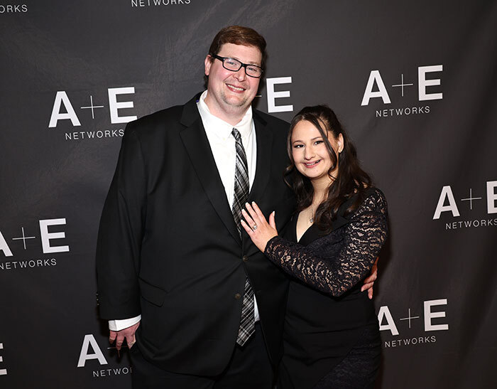 A couple poses at an A+E Networks event. A couple poses at an A+E Networks event.