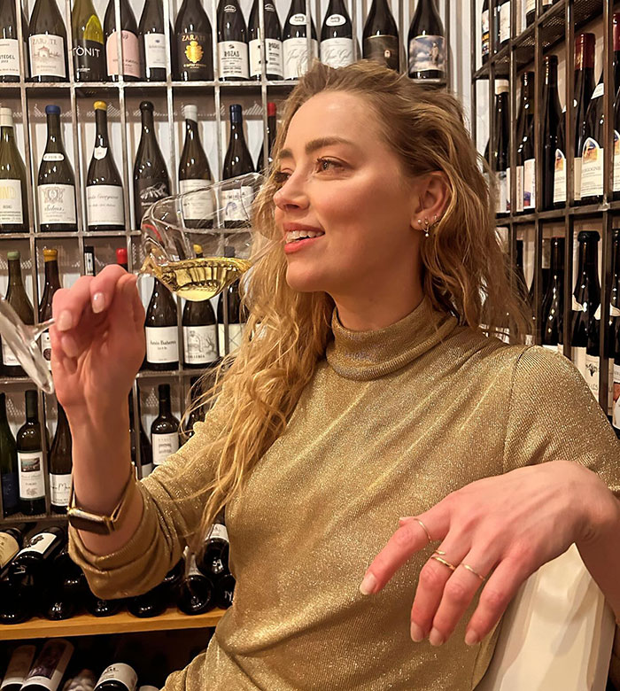 Amber Heard Poses With Champagne Glass In Rare Photo Following Move And Name Change Amber Heard Poses With Champagne Glass In Rare Photo Following Move And Name Change