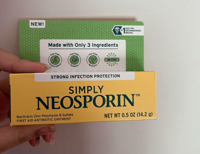 person holding a box of neosporin