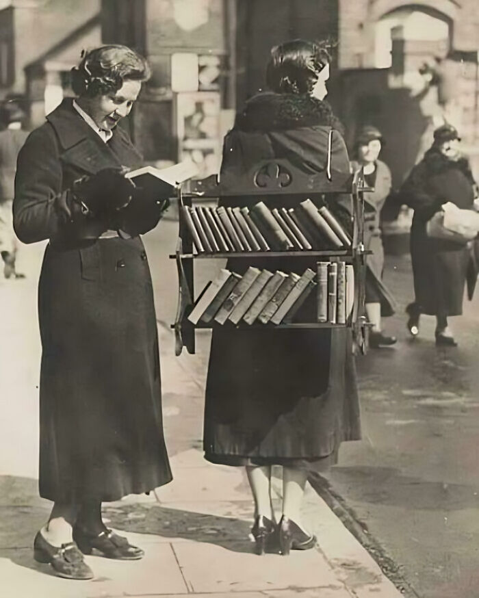 A Lady Walks Around Renting Out Books As A “Walking Library.”