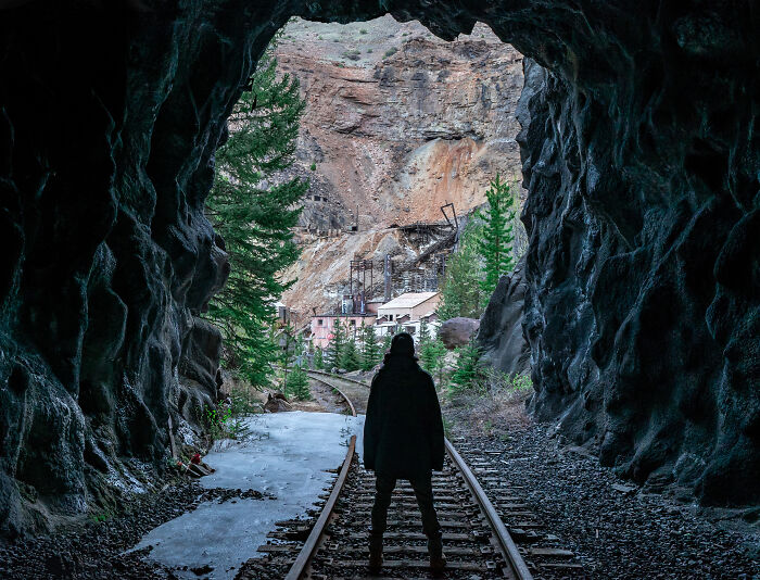 Walking Through A Train Tunnel To Reach An Abandoned Mining Town