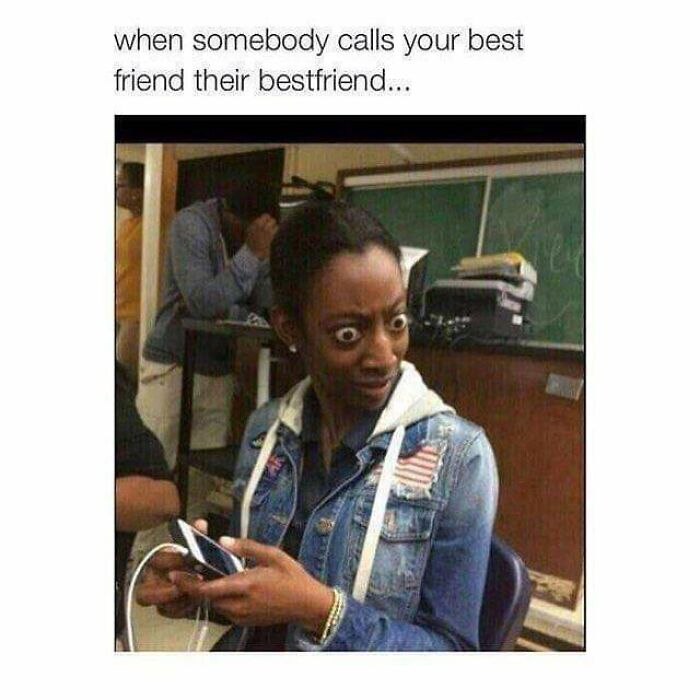 Woman with wide eyes holding a phone, reacting to a meme highlighting common relatable experiences and random memes.