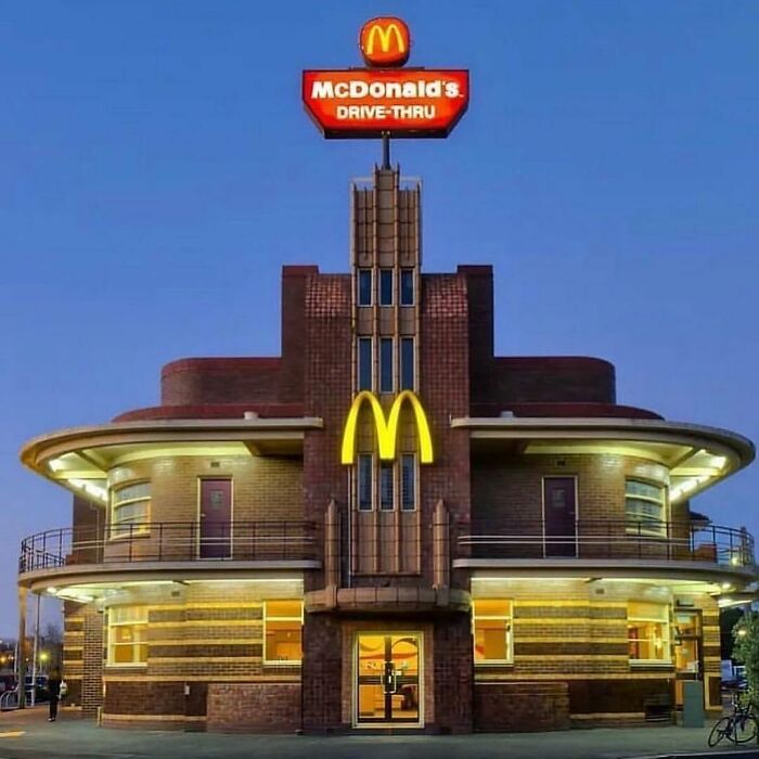 Vintage McDonald's drive-thru building from the nineties with iconic golden arches and retro architecture.