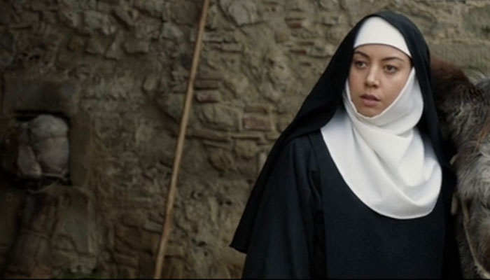 Woman in a nun outfit in a stone-walled setting from a movie scene. Woman in a nun outfit in a stone-walled setting from a movie scene.