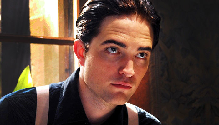 Young actor in a dimly lit room looking upward, portraying a scene associated with movie stars and intimate film moments. Young actor in a dimly lit room looking upward, portraying a scene associated with movie stars and intimate film moments.