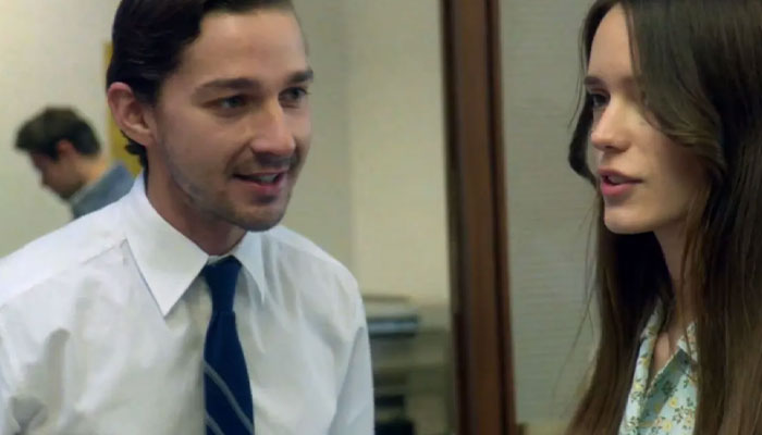 Movie stars in a film scene, wearing office attire and engaging in conversation in an intimate setting. Movie stars in a film scene, wearing office attire and engaging in conversation in an intimate setting.