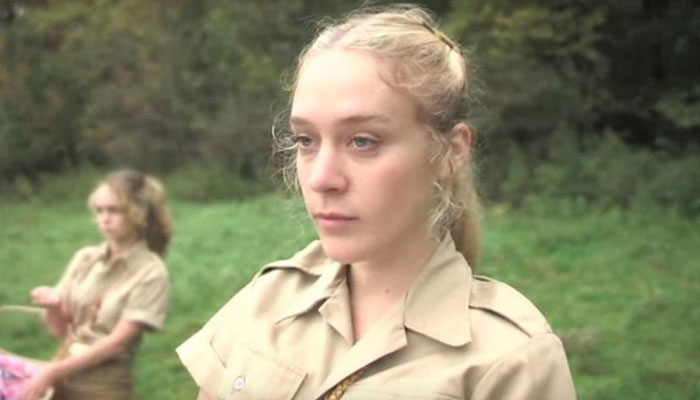 A scene with movie stars in a forest setting, wearing beige uniforms. A scene with movie stars in a forest setting, wearing beige uniforms.