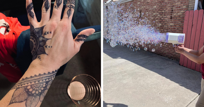 Left hand with intricate henna-inspired tattoo designs, and person using a machine producing a large stream of bubbles outdoors.