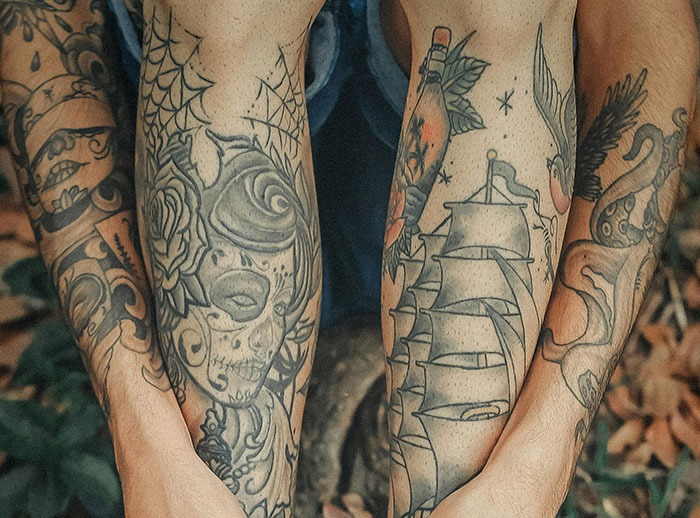 "Close-up of tattooed arms with various designs, related to study on tattoos and cancer. "Close-up of tattooed arms with various designs, related to study on tattoos and cancer.