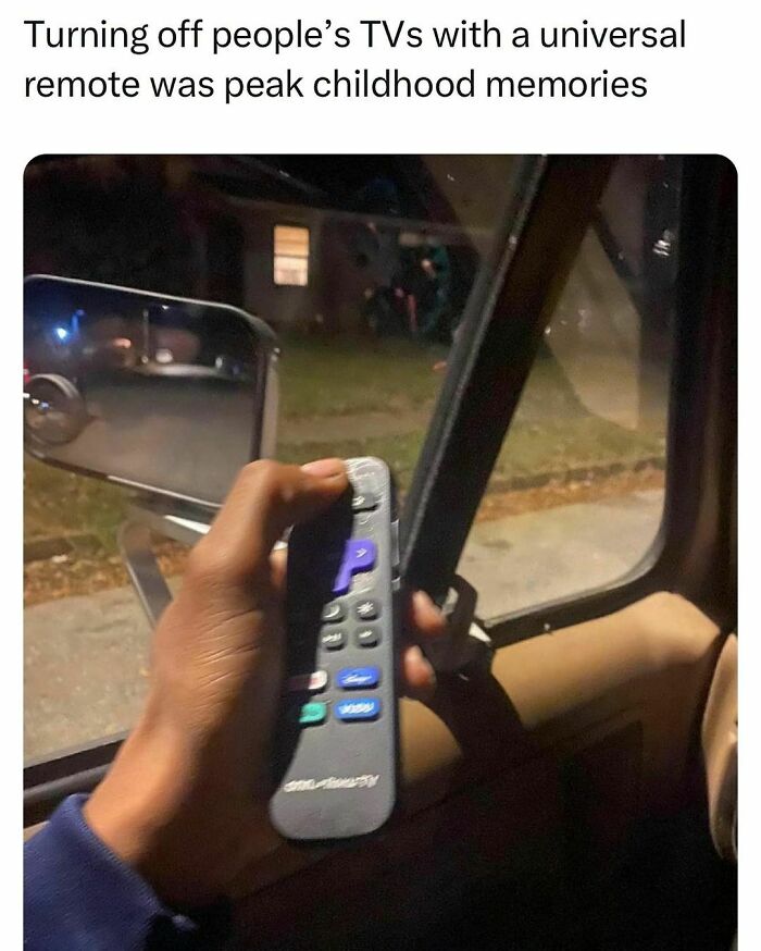 Hand holding a universal remote inside a car, evoking relatable memories for students and young adults.