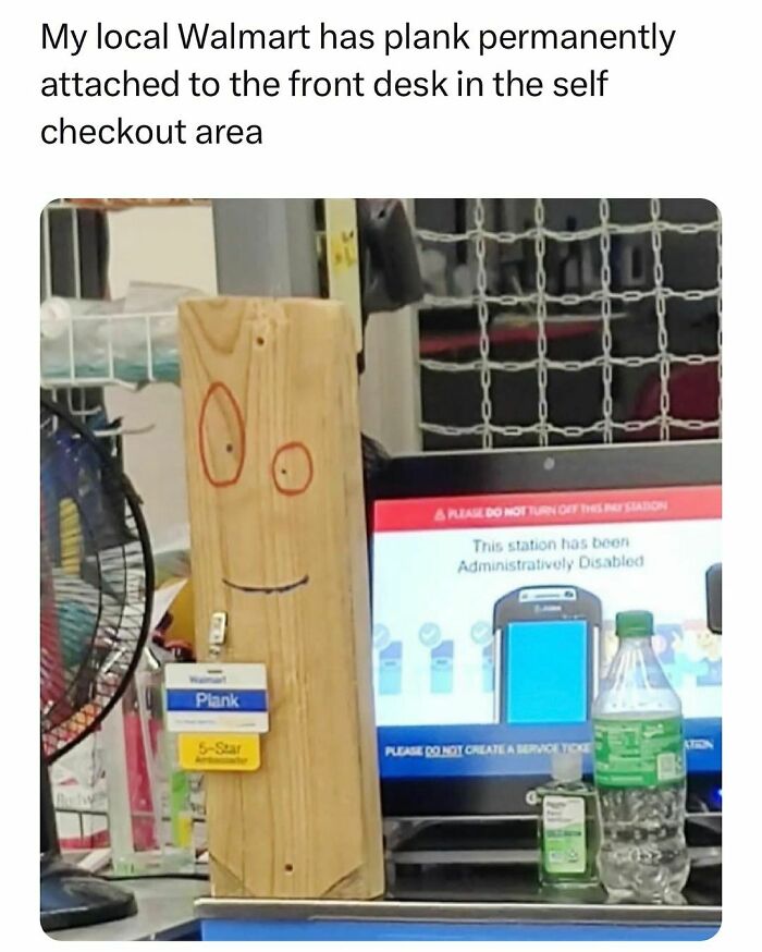 Wooden plank with a smiley face and name tag at a Walmart self-checkout, relatable to students and young adults' lives.