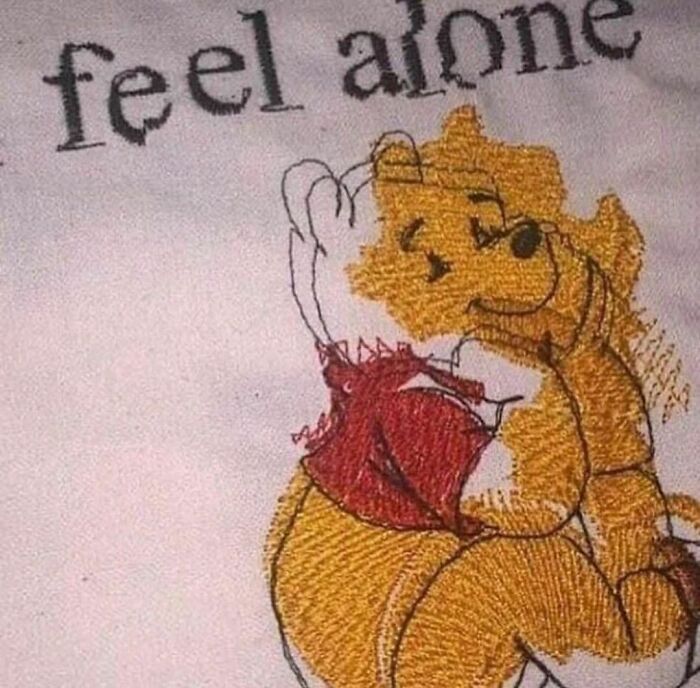 Embroidery of Winnie the Pooh with distorted features and text feel alone, showcasing random and cringe humor style.