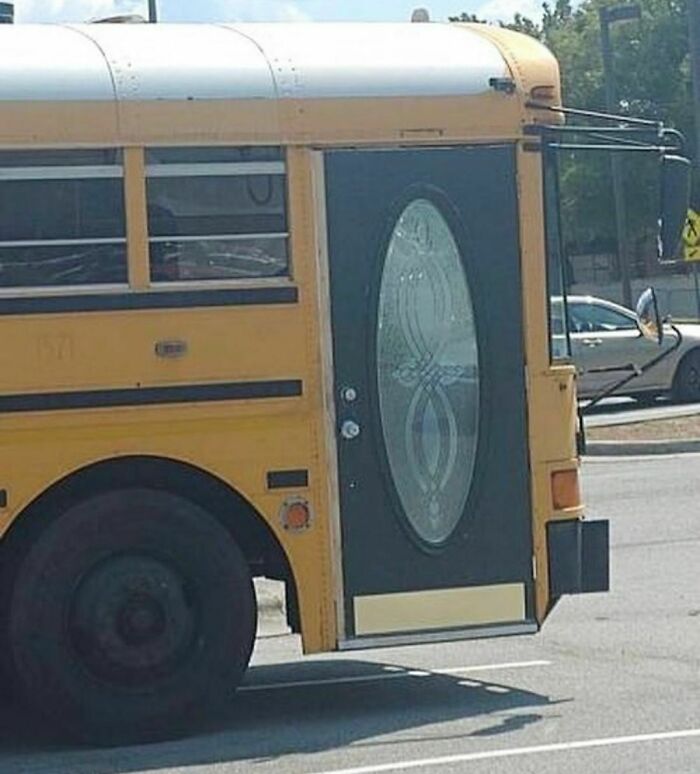School bus with a decorative front door instead of a typical bus entrance, creating a random and cringe visual effect.