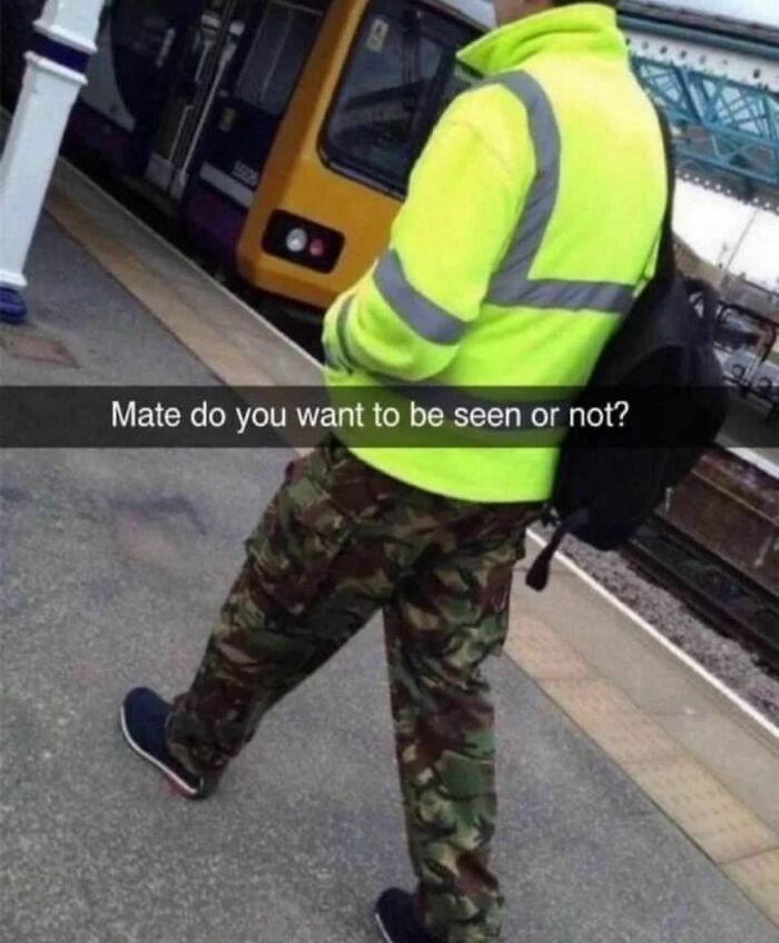 Person in high-visibility jacket and camouflage pants at train station with humorous caption about visibility and cringe humor.