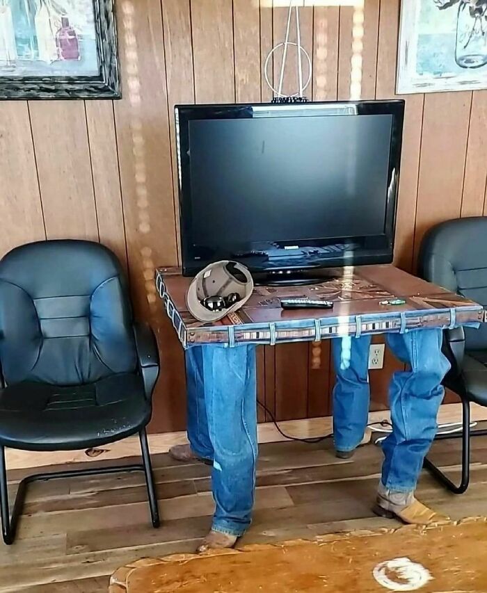 A cringe photo of a TV stand resembling jeans-wearing legs, showing random humor with a unique sense of style.