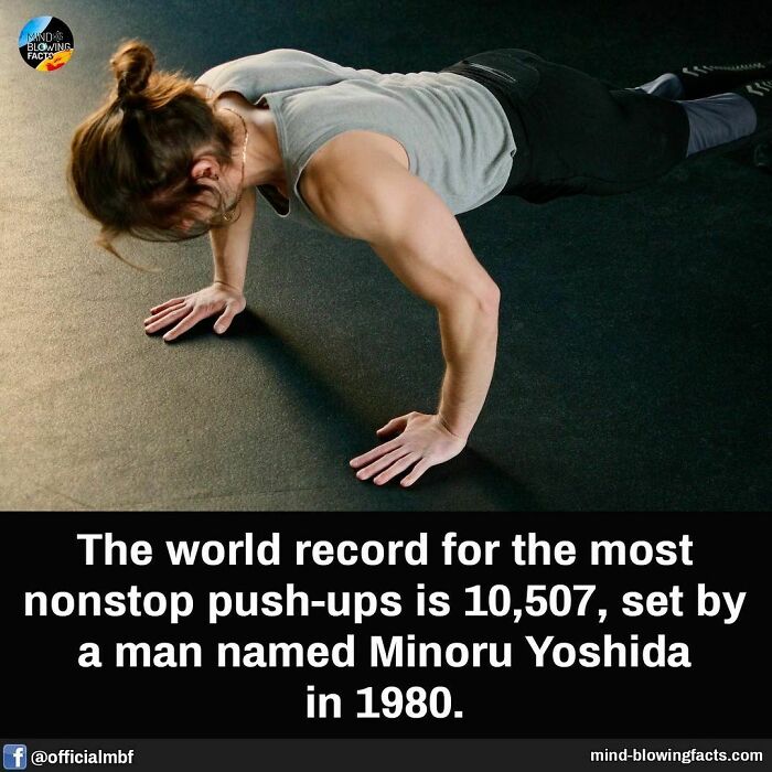 Man doing push-ups on a black floor illustrating mind-blowing facts about world record nonstop push-ups.