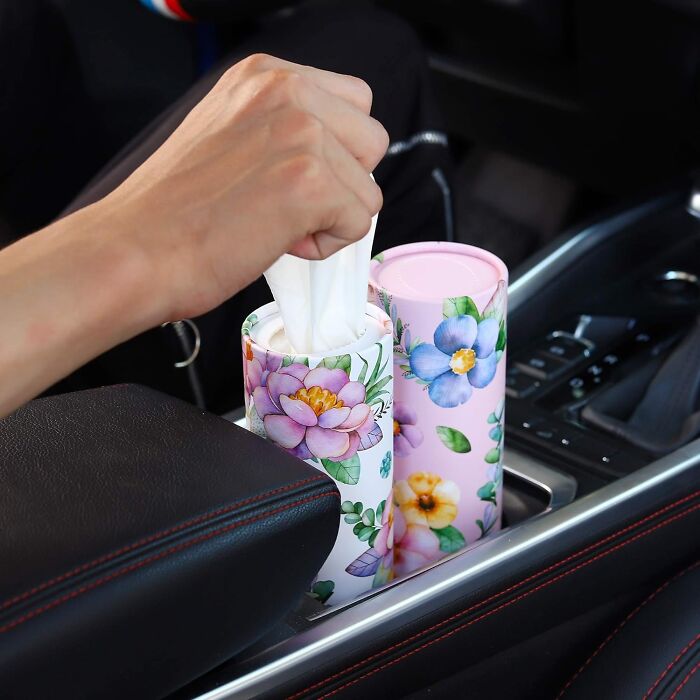 Floral car tissue holder in a cupholder, an innovative car item.