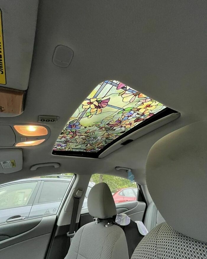 Car sunroof covered with a colorful floral stained glass design to slightly amuse and intrigue passengers inside.