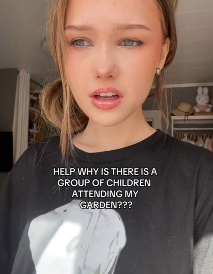 Woman looks baffled inside her home as strangers start having a picnic in her yard unexpectedly. Woman looks baffled inside her home as strangers start having a picnic in her yard unexpectedly.