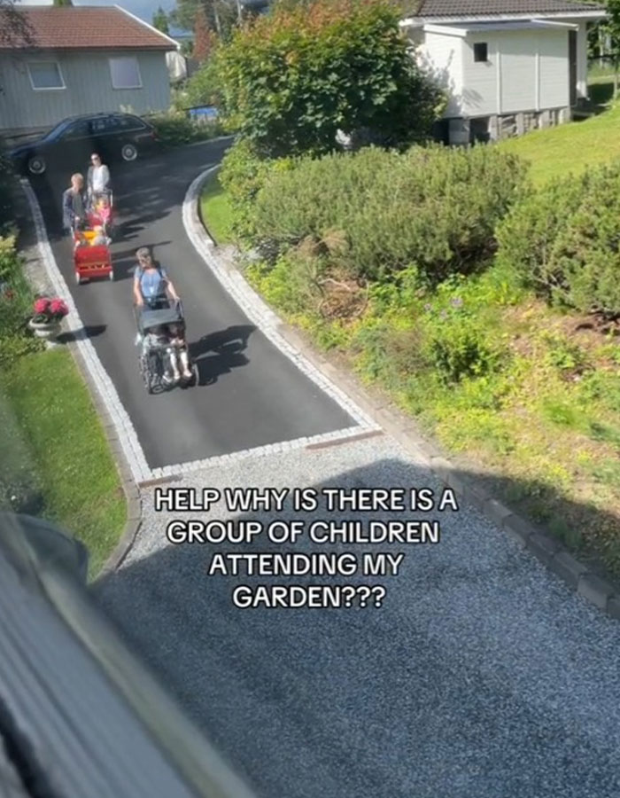 Woman watches baffled as strangers gather having a picnic in her yard on a sunny day near a garden path. Woman watches baffled as strangers gather having a picnic in her yard on a sunny day near a garden path.