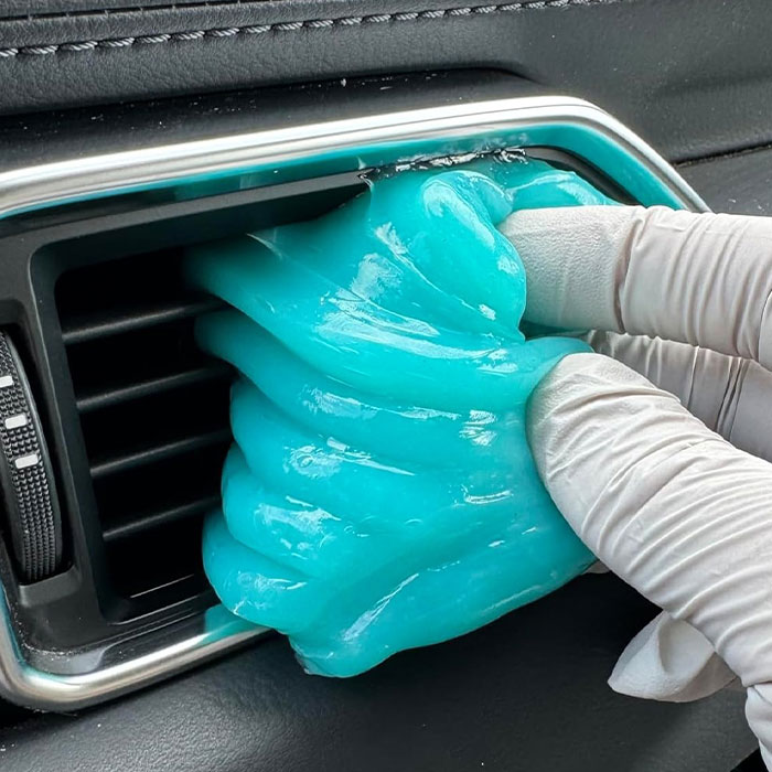 Blue cleaning gel for car detailing on gear shift console.