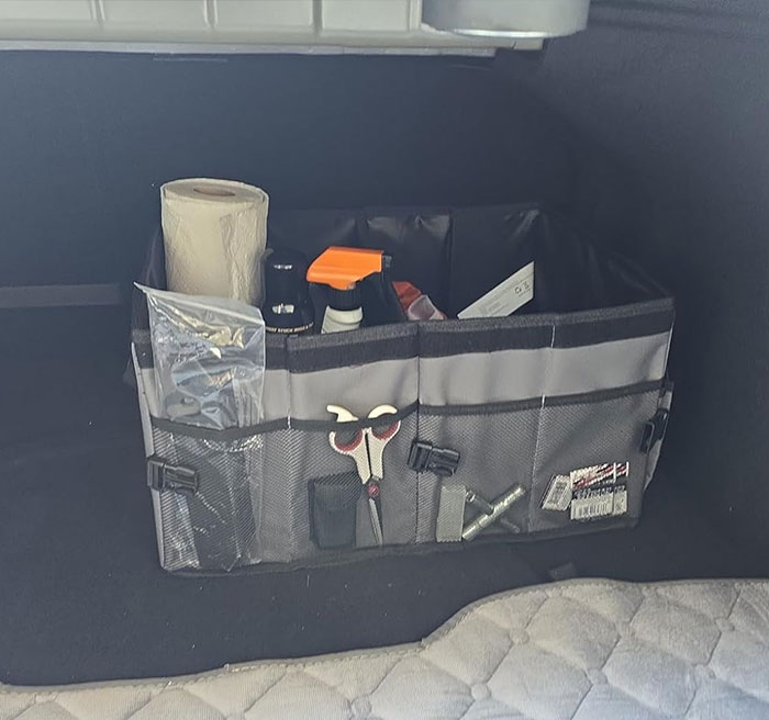 Car trunk organizer with various items, including an abacus, toys, and bags, showcasing clever car items.