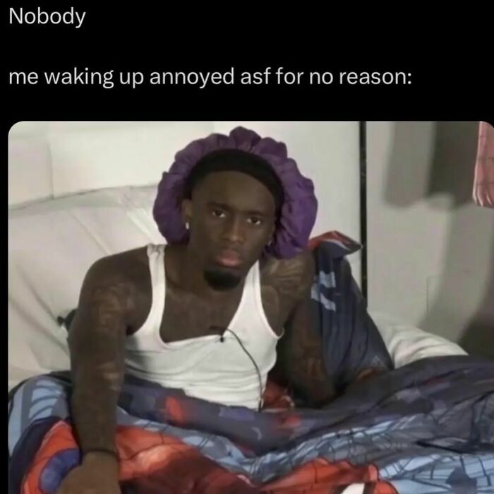 Man in bed wearing a bonnet looking annoyed, relatable meme capturing how work stress affects mood in hilarious way.