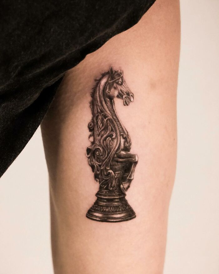 Hyperrealistic horse chess piece tattoo with intricate details on the inner arm. Hyperrealistic horse chess piece tattoo with intricate details on the inner arm.