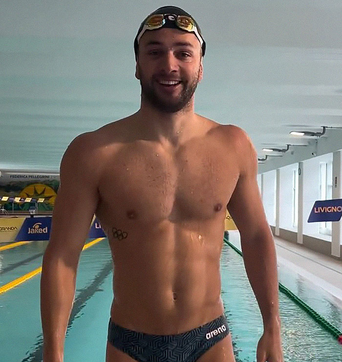 Dutch swimmer at the 2024 Olympics wearing revealing trunks, smiling by the pool. Dutch swimmer at the 2024 Olympics wearing revealing trunks, smiling by the pool.