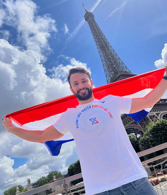 Dutch swimmer with a flag at Eiffel Tower during 2024 Olympics. Dutch swimmer with a flag at Eiffel Tower during 2024 Olympics.