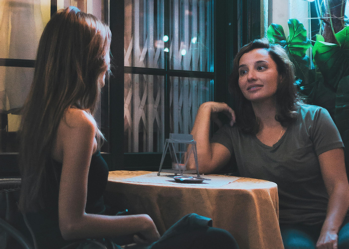 Father and daughter talking at a table, learning modern slang for working with Gen Alpha. Father and daughter talking at a table, learning modern slang for working with Gen Alpha.