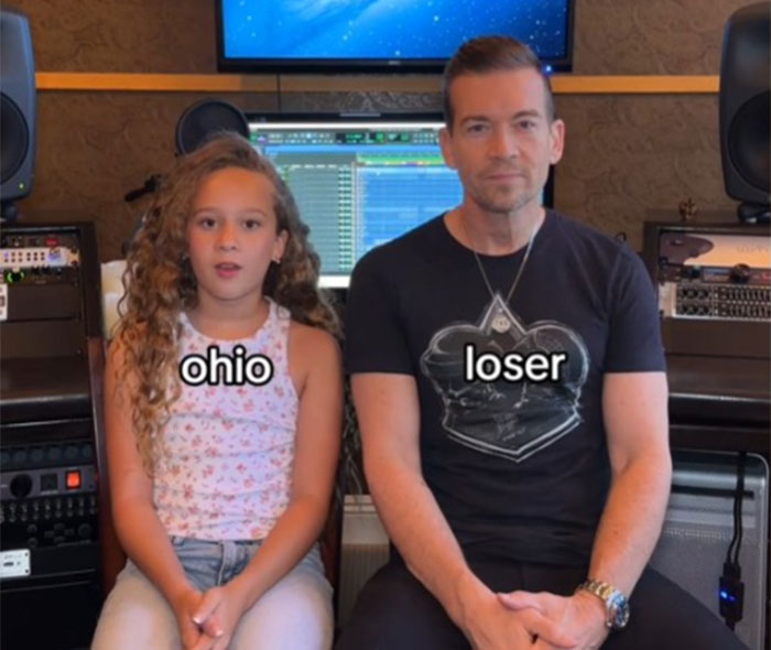 Father learning slang from daughter, seated together in a studio, with screens and speakers in the background. Father learning slang from daughter, seated together in a studio, with screens and speakers in the background.