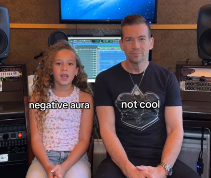 Father learning slang from daughter in a music studio setting, both displaying expressions. Father learning slang from daughter in a music studio setting, both displaying expressions.