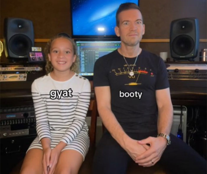 Father and daughter in a recording studio, with captions "gyat" and "booty," teaching slang. Father and daughter in a recording studio, with captions "gyat" and "booty," teaching slang.