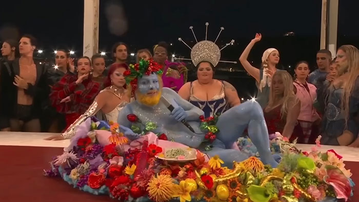 Activist Faces Backlash Over Misinterpreted “Last Supper” Act At Olympics, Files Suit Activist Faces Backlash Over Misinterpreted “Last Supper” Act At Olympics, Files Suit